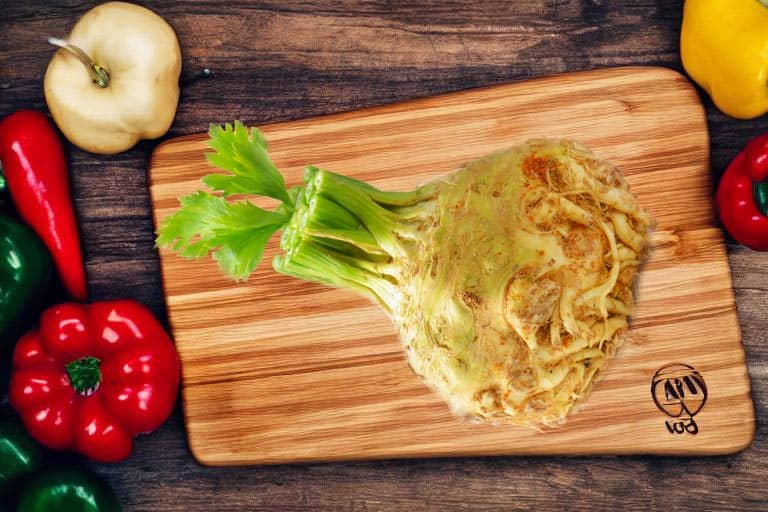 A vegetable with the best herbs for kidney cleansing on a wooden cutting board.
